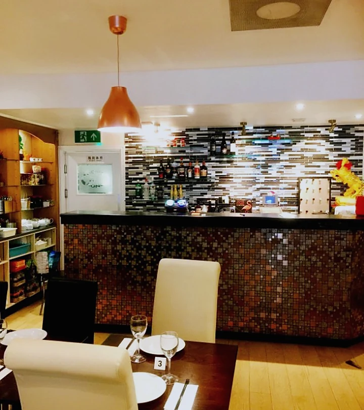 The warm dining room and bar inside East Meets West