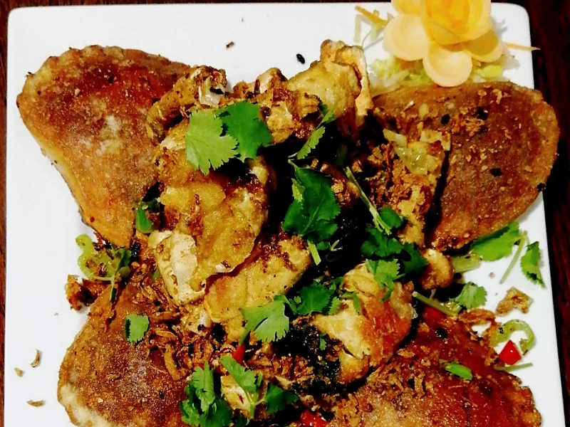 A plated dish with herbs and vegetables