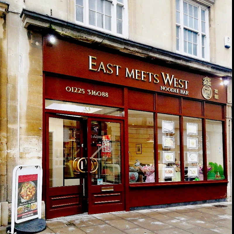 The red East Meets West shopfront on Southgate Street, Bath